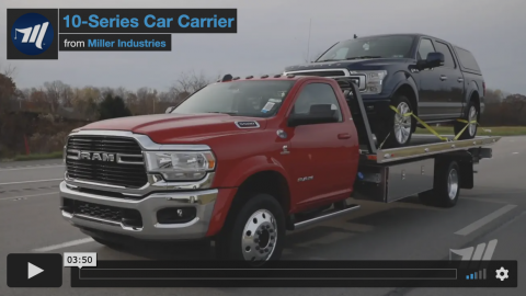 10-series car carrier towing a Fork F150 truck.