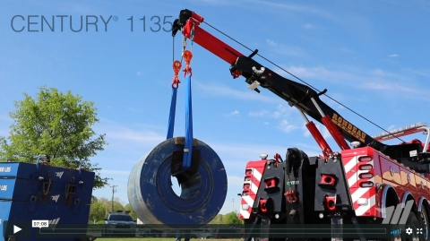 A Century 1135 rotator lifting a steel coil