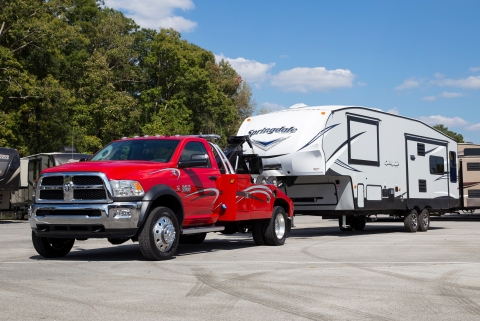 Image of a century light duty wrecker towing a camper using the fifth wheel attachment