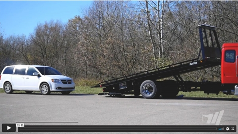 Car carrier proper operations video picture showing a car carrier loading a minivan