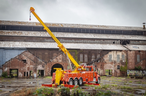 Orange Century 1150 rotator with recovery boom fully elevated and extended.