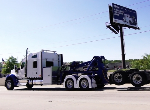A Holmes DTU, detachable towing unit, being used to tow a road tractor down the highway.