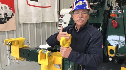 Image of John Hawkins illustrating the proper fit of the towing fork on the truck of a axle.