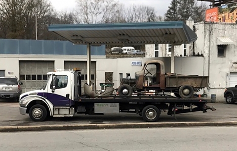 Miller Industries car carrier transporting the old Holmes 330 Junior to the body shop to be restored.