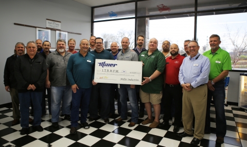 Image of a group of management at Miller Industries presenting a check for over ten thousand dollars to the International Towing and Recovery Museum