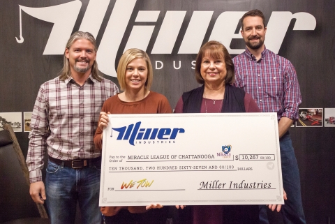 In this photo Joseph Keene, Marketing Manager helps to present a check for over ten thousand dollars to the Miracle League of Chattanooga on behalf of Miller Industries WeTow Campaign.
