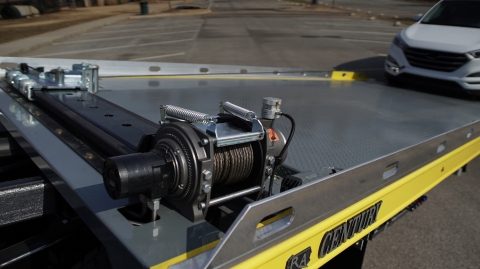 Image of the slide winder winch package installed and in use on a Miller Industries car carrier