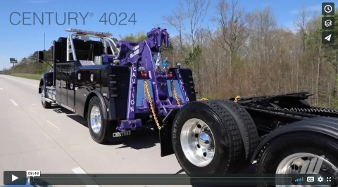 The Century 4024 integrated wrecker towing a road tractor from the rear.